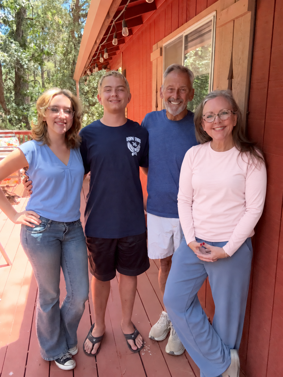 Brenda and her family smiling together on a sunny porch